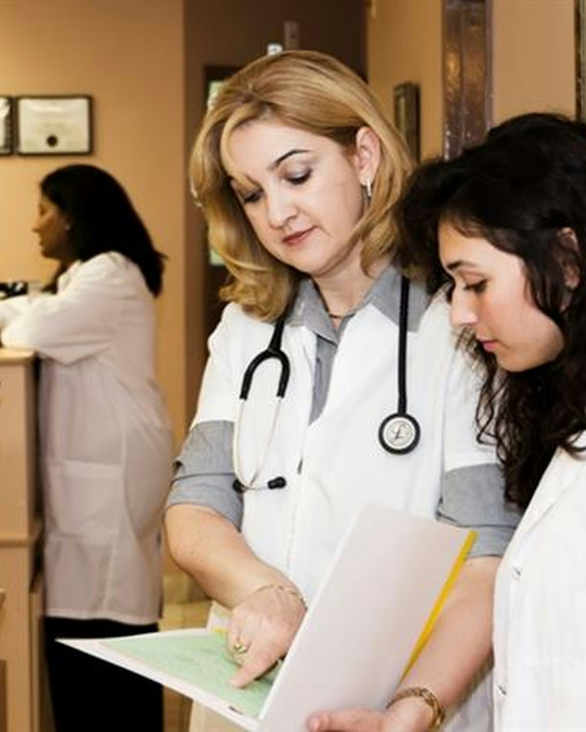 A physician reviewing paperwork with a colleague in a medical office