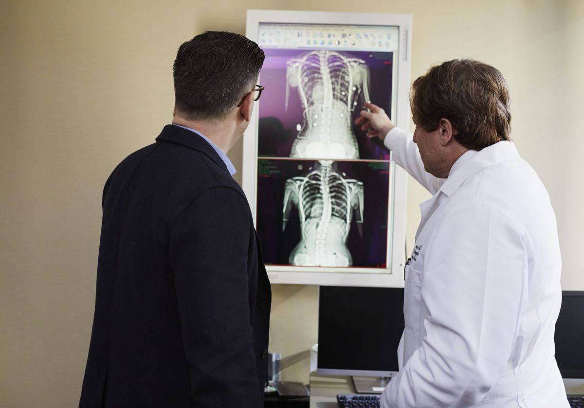 An orthopedic physician explaining an X-ray to a patient