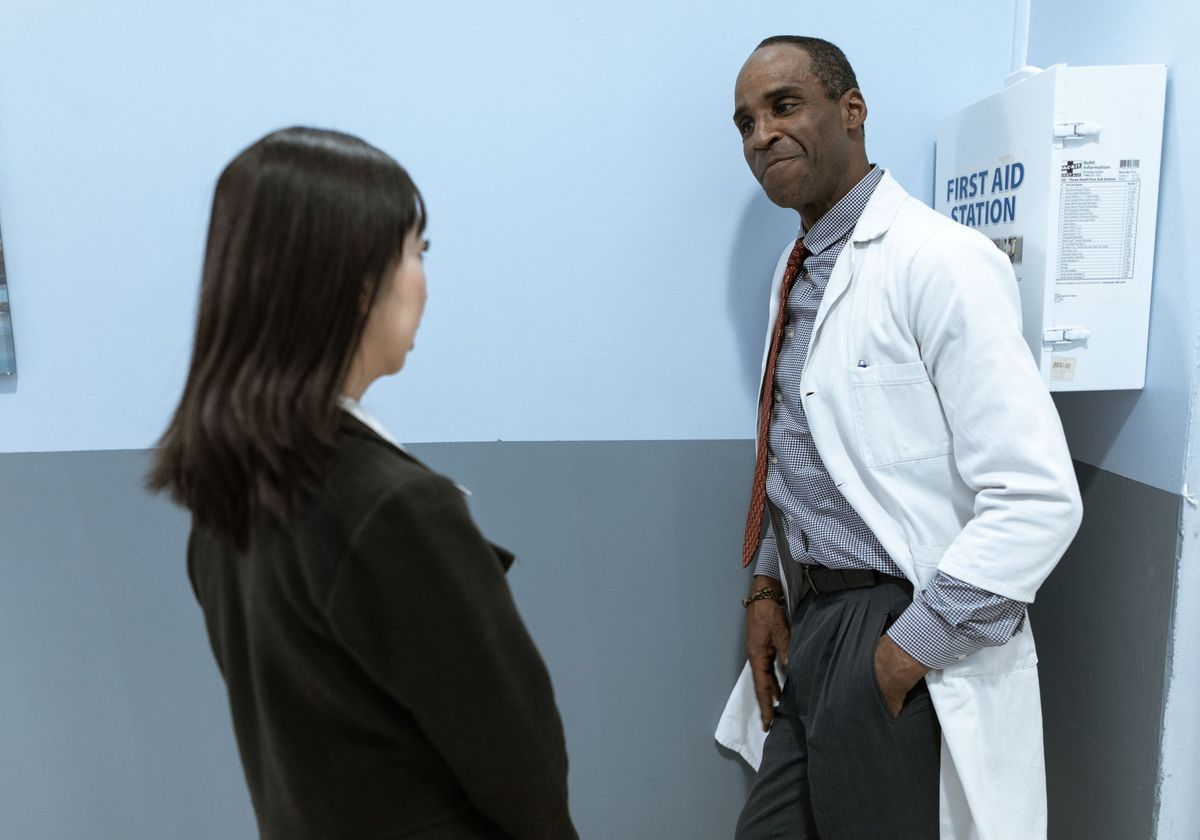 A primary care physician talking with a patient in a bright exam room