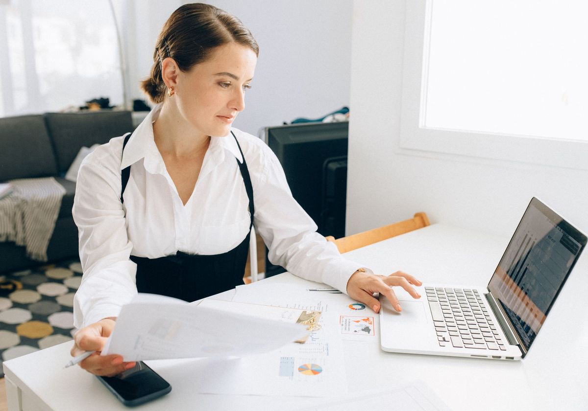 An analyst reviewing revenue reports at her desk