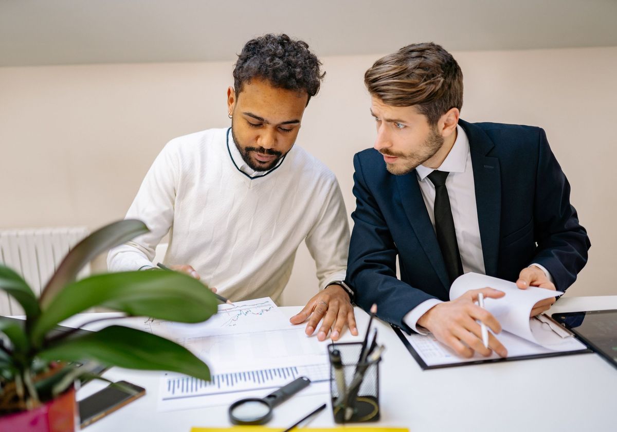 Two administrators reviewing provider credentialing documents